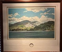 Front view of framed print titled "Casson Lake" by A.J. Casson, with estate seal visible under print and in matting, showing landscape of lake, hills, and sky.