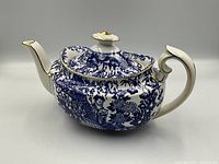 Royal Crown Derby Blue Mikado porcelain teapot with lid, showing side view with spout and handle