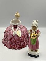 Both Royal Doulton and Royal Worcester porcelain figurines together on neutral background for full lot overview.