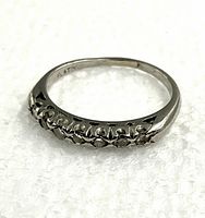 Side angle view of platinum ring showing full band profile with diamond settings