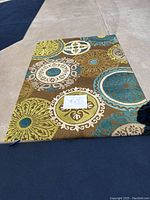 Full view of the 4'x7' colorful hand-tufted area rug laid on pavement showing overall design and colors.