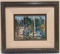 Framed signed artwork showing a harbor with boats docked at piers, surrounded by trees, under glass with visible matting and dark wooden frame.