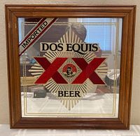 Front-facing photo of a 17x17 wooden framed advertising mirror with Dos Equis beer logo and 'Imported' mark.
