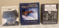 Three coffee table books standing side by side showing front covers: 'Ansel Adams: An Autobiography', 'Images of Nature: The Art of Thomas D. Mangelsen', 'The Photographic History of the Civil War'.