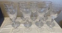 Eight Waterford crystal wine glasses arranged in two rows, showing the overall appearance of all glasses including the gold rim and Hanover cut pattern.
