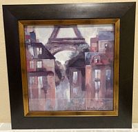 Framed print with black and gold tone frame showing Paris cityscape and Eiffel Tower.