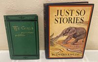 Photo of two books side by side, 'We Girls' by Mrs. A.D.T. Whitney in green cloth and 'Just So Stories' by Rudyard Kipling with illustrated elephant cover