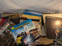 Photo showing an assortment of country music vinyl records including Boxcar Willie, George Jones, Charlie Rich, and Neil Diamond.