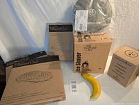 Photo showing all boxed Pampered Chef items stacked with a banana for scale.