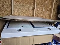 Front view of the Nutone white range hood showing twin ventilation filters, control buttons, and light bulb sockets.