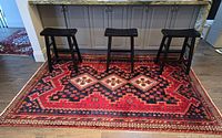 Full view of rug under countertop with stools