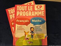 Photo of the two Toulouse Programme Francais Math books with colorful front covers for children aged 6-7, showing titles and categories like Francais and Maths.