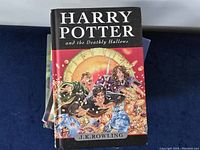 Front cover close-up of Harry Potter and the Deathly Hallows hardcover book showing detailed illustration and title.