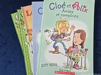 Close-up of the front covers of five books with visible titles and cover art including Cloé et Félix Amies et Complices
