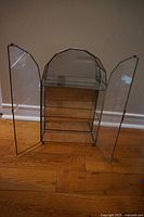 Front view of glass display cabinet with both doors open, showing mirrored back and three glass shelves.