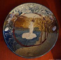 Full view of the round pottery platter showing the Birth of Venus figure and abstract border designs