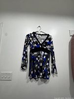 Front view of the long sleeve top on a hanger showing the pattern and colors.