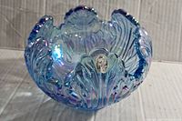 Front angle of the Fenton opalescent lotus bowl showing the shape and iridescent finish.