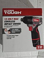 Front of the Hyper Tough 12V Max Cordless Impact Driver box showing key features including 1/4-inch quick-release chuck, variable speed trigger, LED work light, belt clip and 2-year warranty.