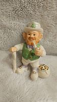 Lenox Irish Leprechaun figurine showing detailed front view with pipe, cane and sack of gold coins