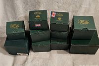 Stack of Harmony Kingdom green boxes of varying sizes, indicating mostly new in box condition