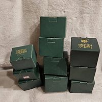 Stacked green Harmony Kingdom boxes showing brand logo and general packaging condition.