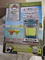 Box packaging of the Margaritaville frozen concoction maker, highlighting the anniversary edition and including images of frozen drinks and product.
