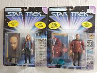 Photo showing both vintage Star Trek Playmates figures in original packaging: Seska as a Cardassian and Admiral William Riker.