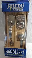 Front view of unopened boxed Toledo electronic door handleset with keypad and handle visible