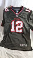 Full front view of black Nike NFL youth jersey with number 12 and Buccaneers name