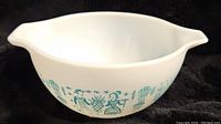 Full view of the white Pyrex bowl showing the blue Amish Butterprint pattern and pouring spouts.