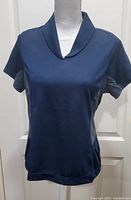 Full front view of North End Sport Cool Logic top, showing short sleeves, navy color, and cowl collar neckline on a mannequin.