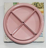 Photo of the pink round serving tray with four triangular compartment dishes arranged inside, showing the serving set in unused condition on original box.