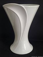 Front view of white Kaiser porcelain vase, showcasing its flared top and sculpted side design.