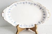 Full top view of the oval ceramic serving tray showing floral pattern and gold trimmed handles