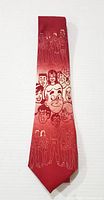 Full length photo of the red necktie showcasing various Archie cartoon characters in lighter red detail on a darker red background.