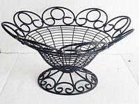 Full front and top view of large black wrought iron centre piece bowl with intricate scrollwork