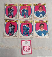 Photo showing all six 1971-72 OPC Toronto Maple Leafs hockey cards together on a fabric surface.