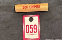 Full unopened roll of 1976 Canadian pennies in original paper wrapping labeled '50¢ COPPERS' with a tag '059'.