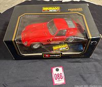 Front view of the boxed Burago Ferrari 250 GTO 1962 die-cast model car showing the red car inside a black display box.