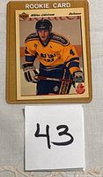Nicklas Lidstrom rookie card, showing front of card with player in yellow Sweden jersey, clear text and logos.
