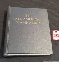 Front cover of the hardcover stamp album titled 'The All American Stamp Album' by Minkus, 1964.