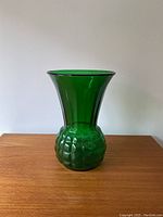 Front view of the vintage green glass vase showing bulbous base and flared top