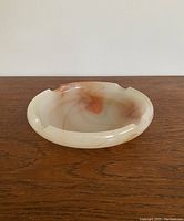 Image of the ashtray showing side angle, highlighting the rounded shape and swirled colors.