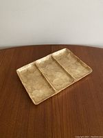 Top-down view of vintage shell tray highlighting the three compartments and shell pattern