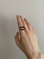 Vintage sterling silver and amber ring shown on hand, side angle highlighting the blend of silver band and amber centerpiece.