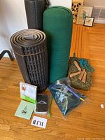 Complete view of the yoga and exercise items including mats, bolster, foam blocks, jump rope, cards, and book.