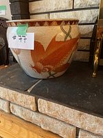 Side view showing large orange koi fish on the ceramic pot with lotus flower and wave patterns.