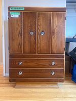 Front view showing double-door cabinet, two lower drawers and green tape dimensions