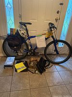 Full view of Trek 3900 bike with panniers, helmet, boxes and accessories on floor